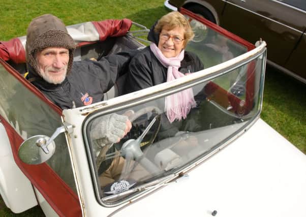 Mike Hele and his wife Renate and their Bond Mini car MkD family model from 1957