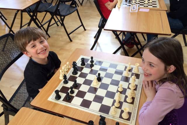 Henri Blin, 4, and Sophia Blin, 6, take part in the chess tournament at Portsmouth High School