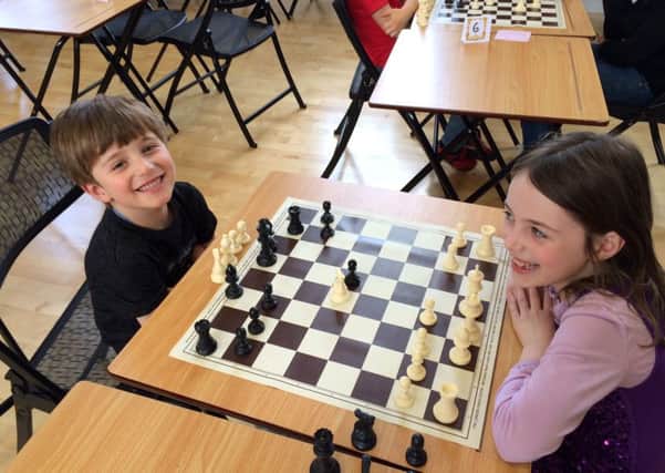 Henri Blin, 4, and Sophia Blin, 6, take part in the chess tournament at
 
Portsmouth High School