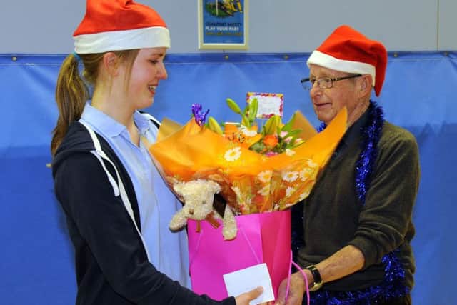 Kathleen Tollerfield, left, is presented with a floral arrangement on behalf of all the members of the group by  Bob HillierPicture:  Malcolm Wells (160406-2636)