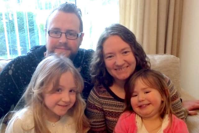 NEW ROLE The Rev Tim Watson with his wife Clare and their two children