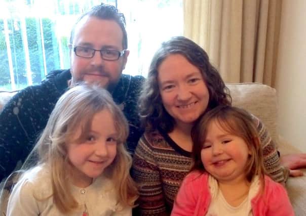 NEW ROLE The Rev Tim Watson with his wife Clare and their two children