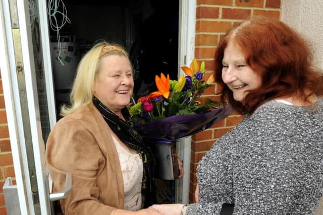 Brenda Ord, right, knocks on her long-lost sister Yvonne Wilkinson's front door in Gosport yesterday - much to her surprise Picture: Malcolm Wells (160412-3034)