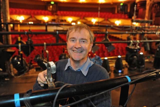 Kings Theatre trustee Ian Pratt works on the lights before a production of Aladdin in 2014