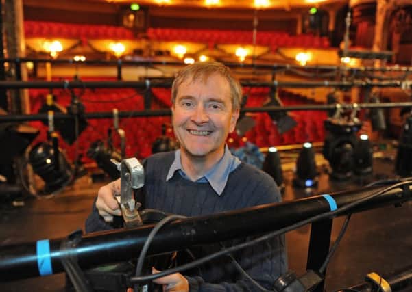Kings Theatre trustee Ian Pratt works on the lights before a production of Aladdin in 2014