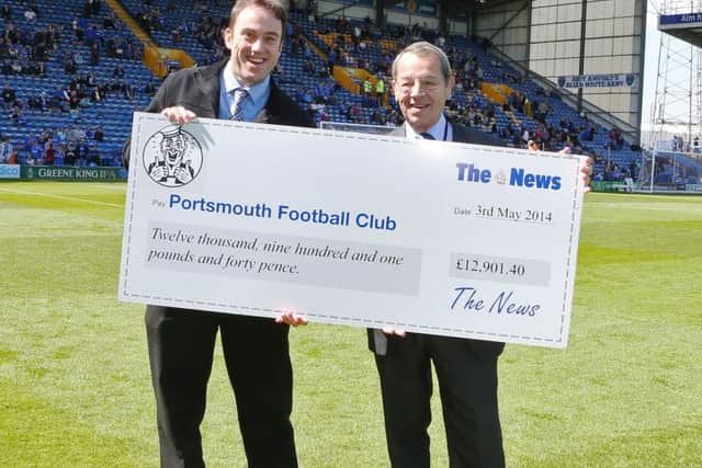 Neil Allen hands over a cheque to former Pompey director Mick Williams for monies raised through the sales of Sports Mails