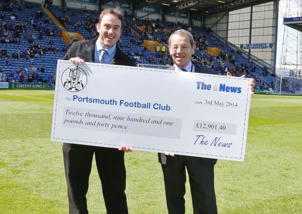 Neil Allen hands over a cheque to former Pompey director Mick Williams for monies raised through the sales of Sports Mails
