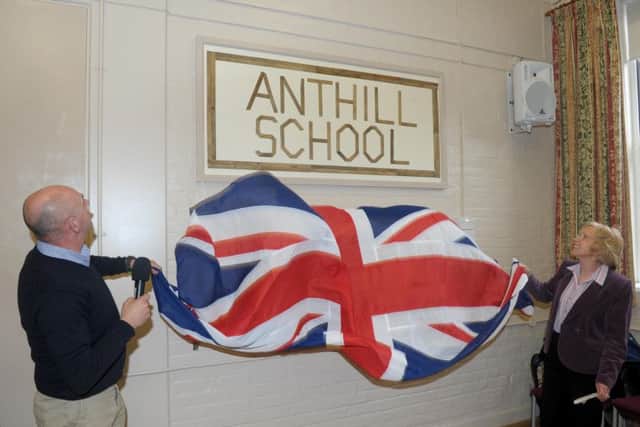 Reunion of Anthill School pupils which is now Denmead Community Centre. More than 100 rulers were found under the hall floor whilst it was being restored, which have been used to make a memorial to the school. Bob Bainbridge MBE and Patricia Stallard do the unveiling.  Picture: Paul Jacobs (160237-5)