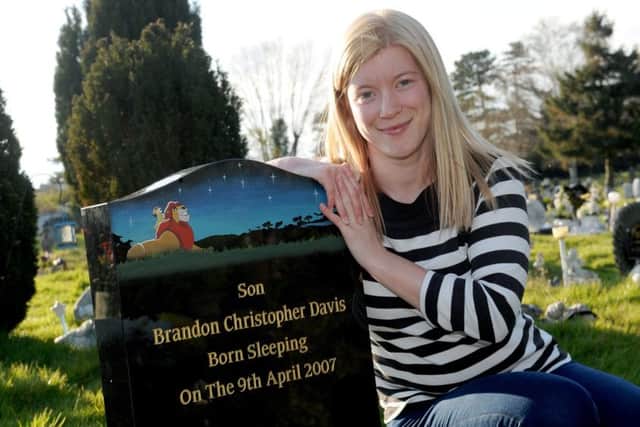 Lucy Maidens (29) next to her son Brandon Davis's grave at Waterlooville Cemetery. Picture: Sarah Standing (160615-2875)
