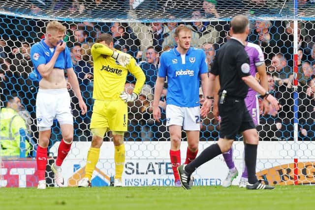 The Pompey players look dejected at the final whistle Picture: Joe Pepler