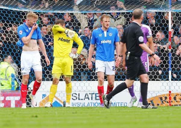 The Pompey players look dejected at the final whistle Picture: Joe Pepler
