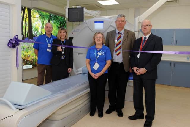 The new CT scanner unveiled at Queen Alexandra Hospital can perform a chest scan in just two seconds.
From left, League of Friends Peter Gorvin, superintendent of CT and MR scanning Nicki Wragg, Jan Satchell from the League of Friends, clinical director of diagnostic imaging services Nigel Cowan and Mark Foxall from Toshiba
Picture: Sarah Standing (160319-2683)