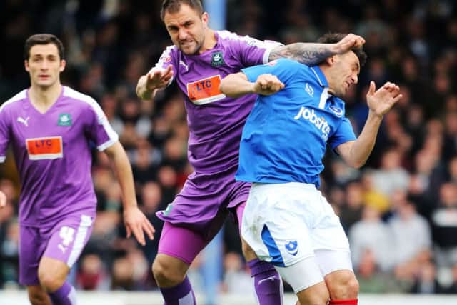 Gary Roberts is elbowed in the head by Plymouth's Peter Hartley Picture: Joe Pepler