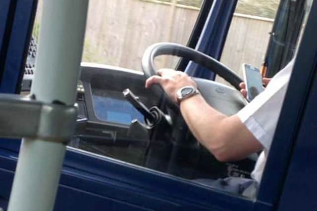 The Eclipse driver pictured using his phone while behind the wheel, taken by teenager Emmy Thornton
