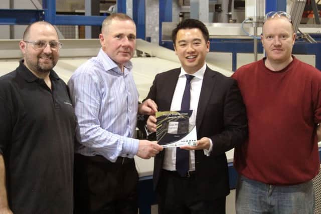Havant MP Alan Mak with staff at Lewmar and one of the new trophies. From left, Mark Wood, Peter Tierney, Mr Mak and Matthew Freeland
