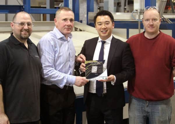 Havant MP Alan Mak with staff at Lewmar and one of the new trophies. From left, Mark Wood, Peter Tierney, Mr Mak and Matthew Freeland