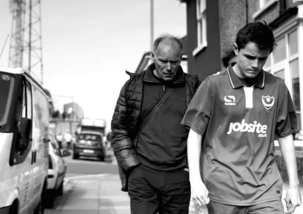 One of Andrew Malbon's images, showing a father and son walking home after a Pompey match