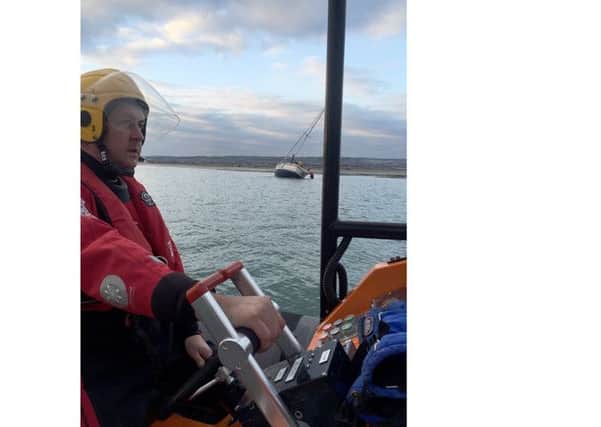 Gafirs coxswain Brian Pack mans Gosport lifeboat while crew member Phil Butler assists the stricken vesse