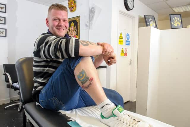Pompey fan James Sullivan with the Southampton FC tattoo on his leg, done by by Bob Hansler at Havant Ink, Havant. 

Picture: Allan Hutchings (160412-125)