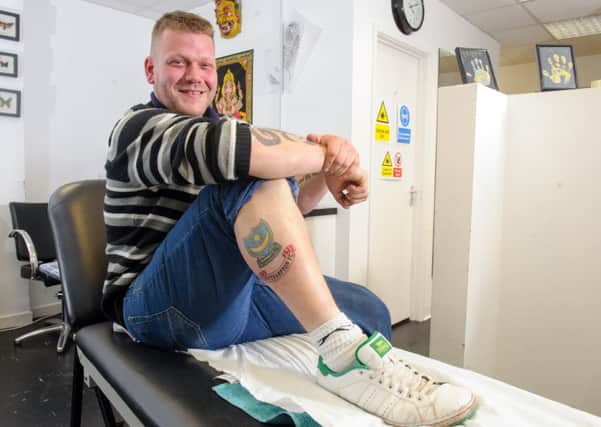 Pompey fan James Sullivan with the Southampton FC tattoo on his leg, done by by Bob Hansler at Havant Ink, Havant. 

Picture: Allan Hutchings (160412-125)