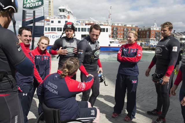 Sir Ben Ainslie, centre, welcomes members of the Invictus Games UK Team, including Portsmouths Zoe Williams, second left, to the Land Rover BAR base in old Portsmouth