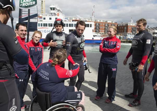 Sir Ben Ainslie, centre, welcomes members of the Invictus Games UK Team, including Portsmouths Zoe Williams, second left, to the Land Rover BAR base in old Portsmouth