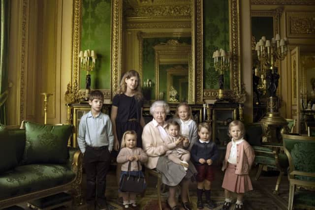 This official photograph, released by Buckingham Palace to mark her 90th birthday, shows Queen Elizabeth II with her five great-grandchildren and her two youngest grandchildren in the Green Drawing Room, part of Windsor Castle's semi-State apartments. The children are: James, Viscount Severn (left), 8, and Lady Louise (second left), 12, the children of The Earl and Countess of Wessex;  Mia Tindall (holding The Queen's handbag), the two year-old-daughter of Zara and Mike Tindall; Savannah (third right), 5, and Isla Phillips (right), 3, daughters of The Queen's eldest grandson Peter Phillips and his wife Autumn; Prince George (second right), 2, and in The Queen's arms and in the tradition of Royal portraiture, the youngest great-grandchild, Princess Charlotte (11 months), children of The Duke and Duchess of Cambridge. Â© 2016 Annie Leibovitz / PA Wire