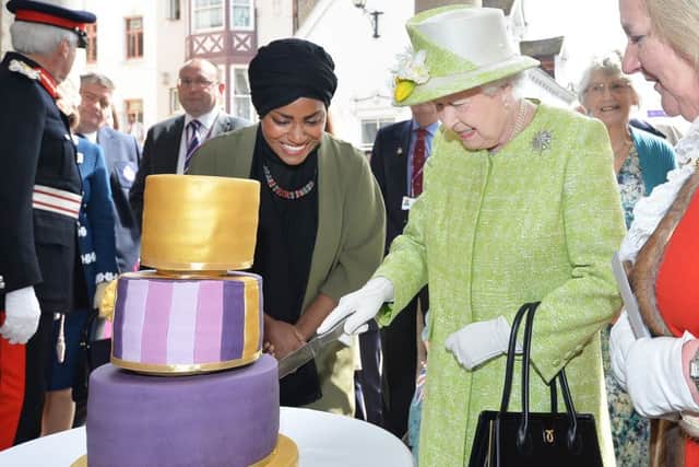 Queen Elizabeth II with Nadiya Hussain, winner of the Great British Bake Off who baked a cake for her, during a walkabout close to Windsor Castle in Berkshire as she celebrates her 90th birthday. Photo: John Stillwell/PA Wire