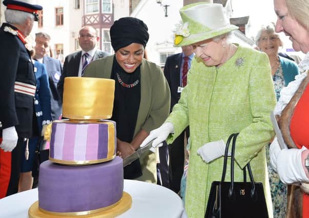 Queen Elizabeth II with Nadiya Hussain, winner of the Great British Bake Off who baked a cake for her, during a walkabout close to Windsor Castle in Berkshire as she celebrates her 90th birthday. Photo: John Stillwell/PA Wire