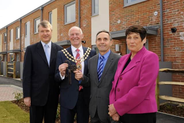 Fareham Borough Council has funded six new eco-homes built in Sarisbury Green to the Passivhaus standard, which were finished recently - but the authority needs to find Â£23m to improve other housing that it owns. 
Pictured at the key handover for the Passivhaus homes are, from left, Cllr SeÃ¡n Woodward, Mayor of Fareham Cllr Mike Ford, divisional director for builders Interserve Justin Elliott and executive member for health and housing Cllr Kay MandryPicture: Malcolm Wells (160323-1107)
