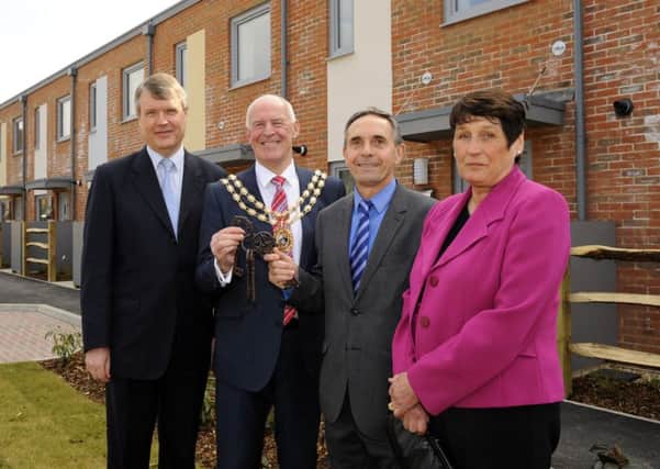 Fareham Borough Council has funded six new eco-homes built in Sarisbury Green to the Passivhaus standard, which were finished recently - but the authority needs to find Â£23m to improve other housing that it owns. 
Pictured at the key handover for the Passivhaus homes are, from left, Cllr SeÃ¡n Woodward, Mayor of Fareham Cllr Mike Ford, divisional director for builders Interserve Justin Elliott and executive member for health and housing Cllr Kay Mandry

Picture: Malcolm Wells (160323-1107)