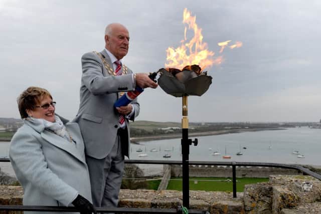 The Mayoress and Mayor of Fareham Anne and Mike Ford light the beacon at Portchester Castle Picture: Sarah Standing (160634-4563)