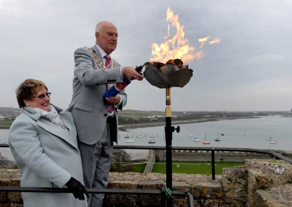 The Mayoress and Mayor of Fareham Anne and Mike Ford light the beacon at Portchester Castle 

Picture: Sarah Standing (160634-4563)