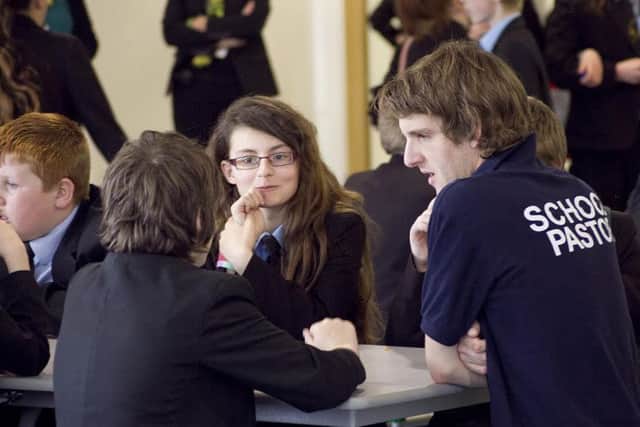 A school pastor talks to pupils