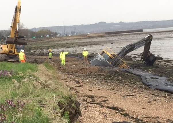 Excavator stuck in mud while working along Langstone Harbour