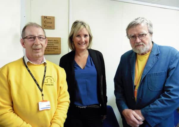 Harry Ansell, from Gosport Men's Shed, with Caroline Dinenage and founder of the group Martin Corrick

The group has opened bigger premises