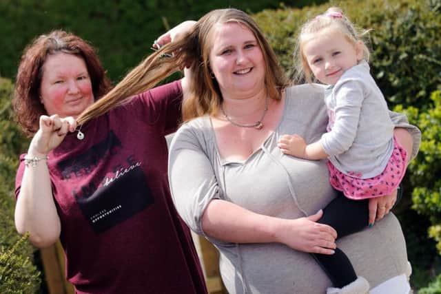 From left, Sarah Carter, Donna Coney and Stevi-Mai Coney, three.
Donna is getting her head shaved tomorrow to raise money for Cancer Research UK in memory of her dad Martin who died of cancer a year ago
Picture: Allan Hutchings (160411-243)