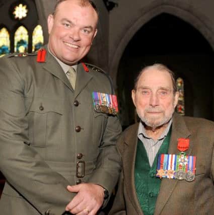 Colonel Mike Tanner, captain of Portsmouth Naval Base with George Higgins. Picture: Sarah Standing (160638-4821)