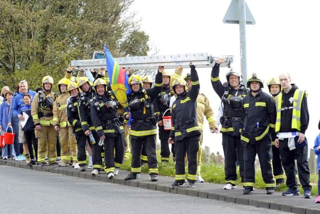 Firefighters carrying the ladder at Portsdown Hill Picture: Malcolm Wells