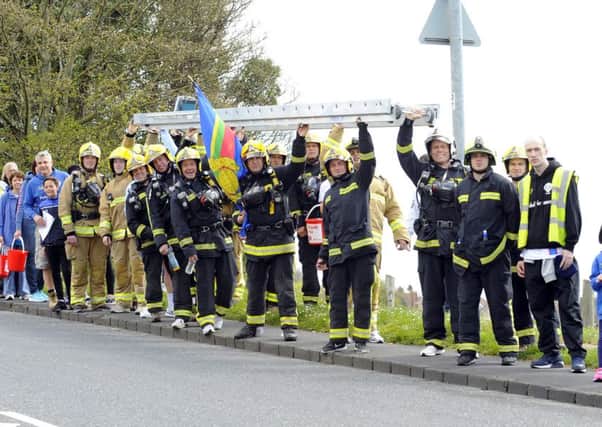 Firefighters carrying the ladder at Portsdown Hill Picture: Malcolm Wells