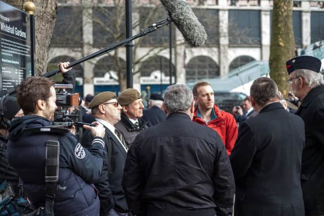 Director Aaron Sayers, in red, interviews Veterans on the UK Veterans One Voice March from Whitehall