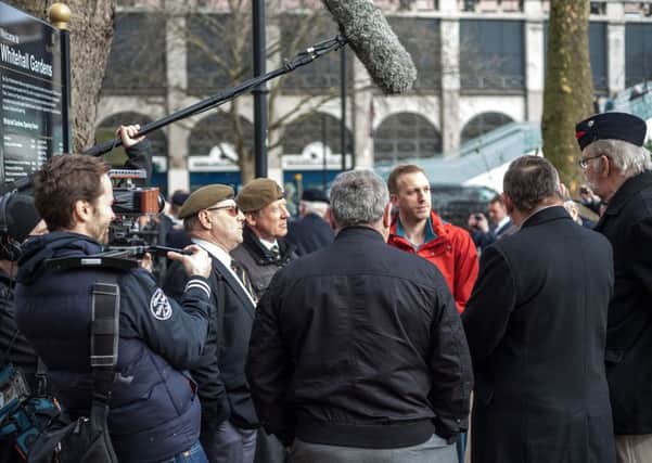 Director Aaron Sayers, in red, interviews Veterans on the UK Veterans One Voice March from Whitehall