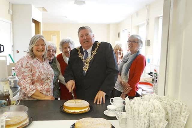 City Lord Mayor Frank Jonas cuts the cake at a new Community Cafe in Anchorage Park