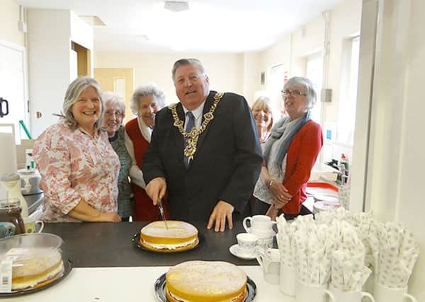 City Lord Mayor Frank Jonas cuts the cake at a new Community Cafe in Anchorage Park