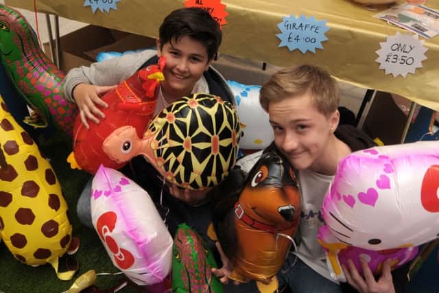 Young fundraisers Bradley Harding-Martin, 13, left, and Liam Percival sell their animal balloons in the Cascades Centre, Portsmouth Picture Mick Young (160478-02)