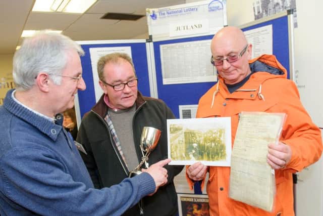 Steve Doe from Portsdown U3A, speaking with Mick Jasper and brother Roger Jasper about their grandfather Albert Edward Jasper at Portsmouth Central Library Picture: Allan Hutchings (160409-488)