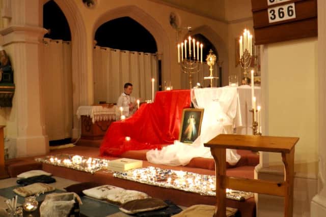 Guests can kneel in front of the decorated altar in St Marys RC Church, Gosport