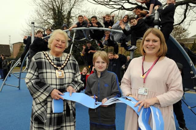 The Mayor of Havant Cllr. Leah Turner with Year 6 pupil Bailey Gee (10), and the Headteacher of The Waterloo School Kirsty Roman cutting the 'opening ribbon' ! The super new playground replaces one that was subject previously of an arson attack Picture by:  Malcolm Wells (160318-0774)