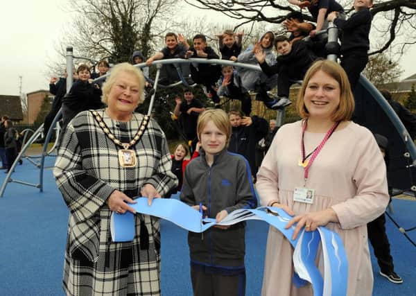 The Mayor of Havant Cllr. Leah Turner with Year 6 pupil Bailey Gee (10), and the Headteacher of The Waterloo School Kirsty Roman cutting the 'opening ribbon' ! 
The super new playground replaces one that was subject previously of an arson attack 

Picture by:  Malcolm Wells (160318-0774)