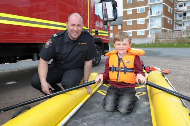 Dave Cox, Hayling crew manager with Jake Anderson at an emergency services day to promote water safety on Hayling Island seafront   Picture: Paul Jacobs (160247-2)